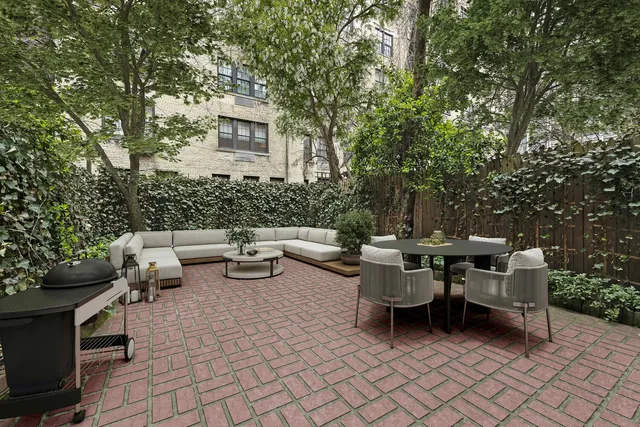 a living room with furniture and a potted plant