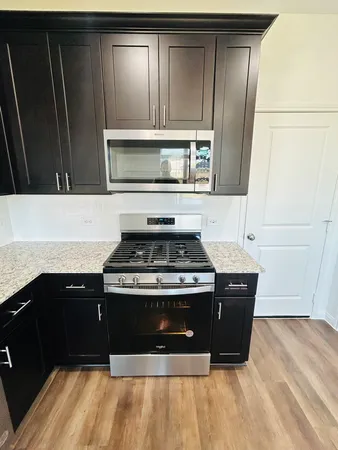 a kitchen with wooden cabinets and a stove top oven