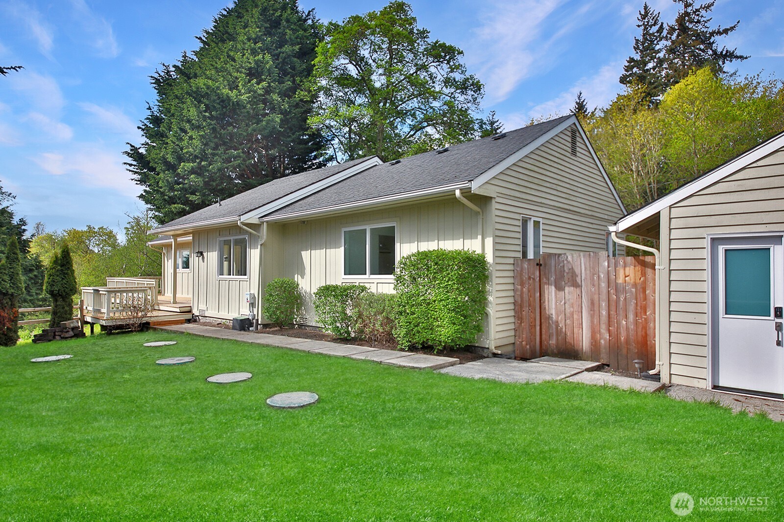 3760 Periwinkle Road Clinton, WA 98236 - Photo 4 of 34 a view of a house with a yard and sitting area