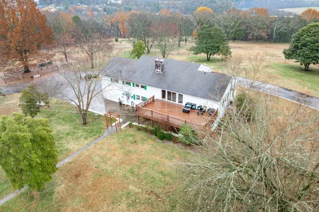an aerial view of residential houses with outdoor space and river