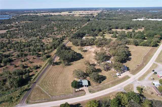 an aerial view of mountain with residential house and ocean view