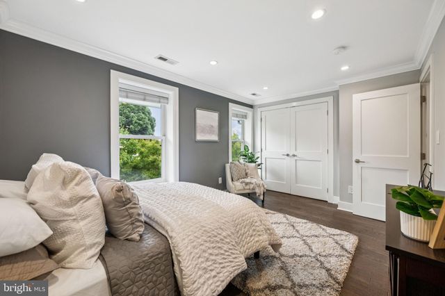 a spacious bedroom with a bed and a window