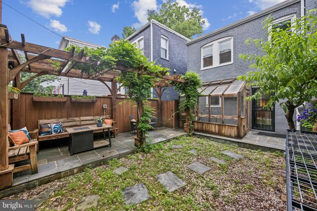 a backyard of a house with yard and outdoor seating