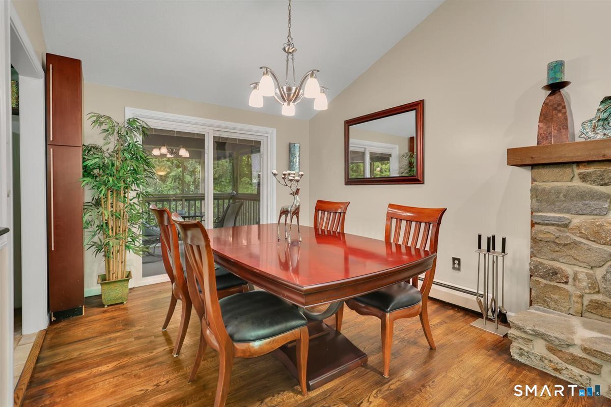 122 Ridgeview Circle Guilford, CT 06437 - Photo 7 of 40 The living room flows easily into the dining room, where a slider opens to a lovely screened-in porch, ideal for relaxing and enjoying the outdoors.
