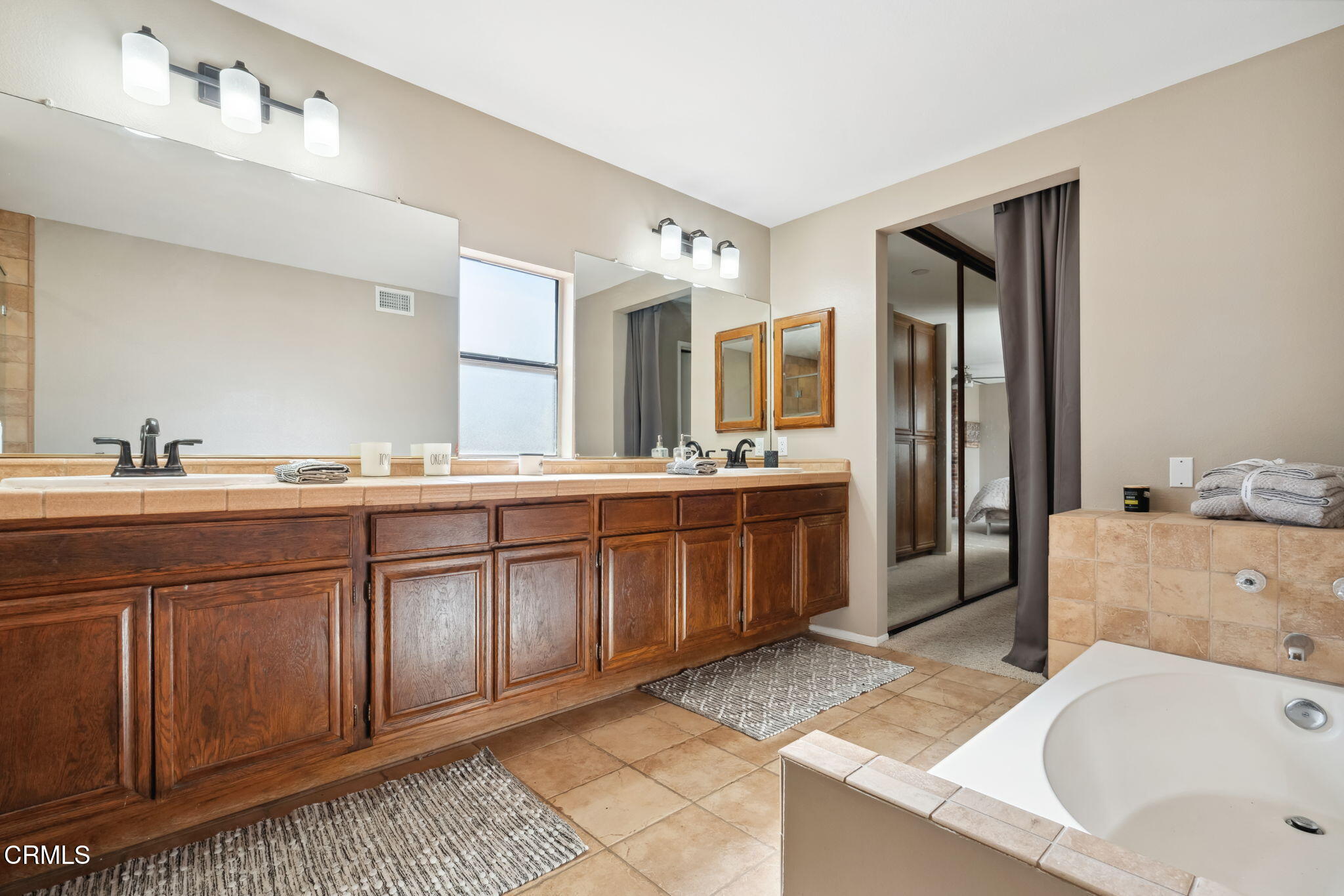 4293 Peach Slope Road Moorpark, CA 93021 - Photo 21 of 36 a bathroom with a granite countertop double vanity sink a mirror and bathtub