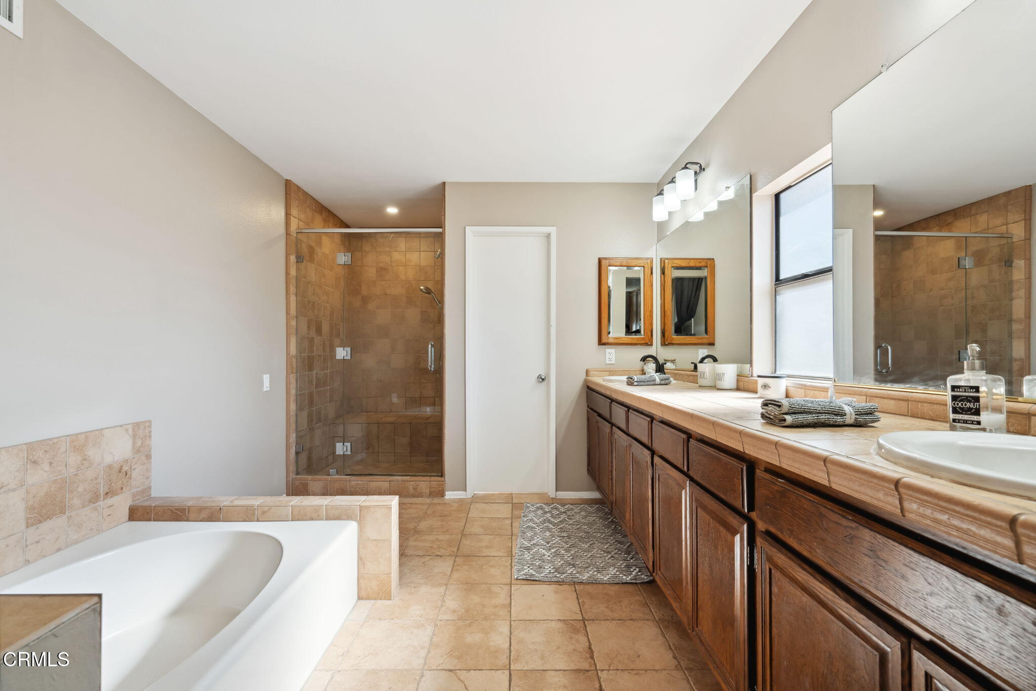 4293 Peach Slope Road Moorpark, CA 93021 - Photo 22 of 36 a spacious bathroom with a bathtub sink and mirror