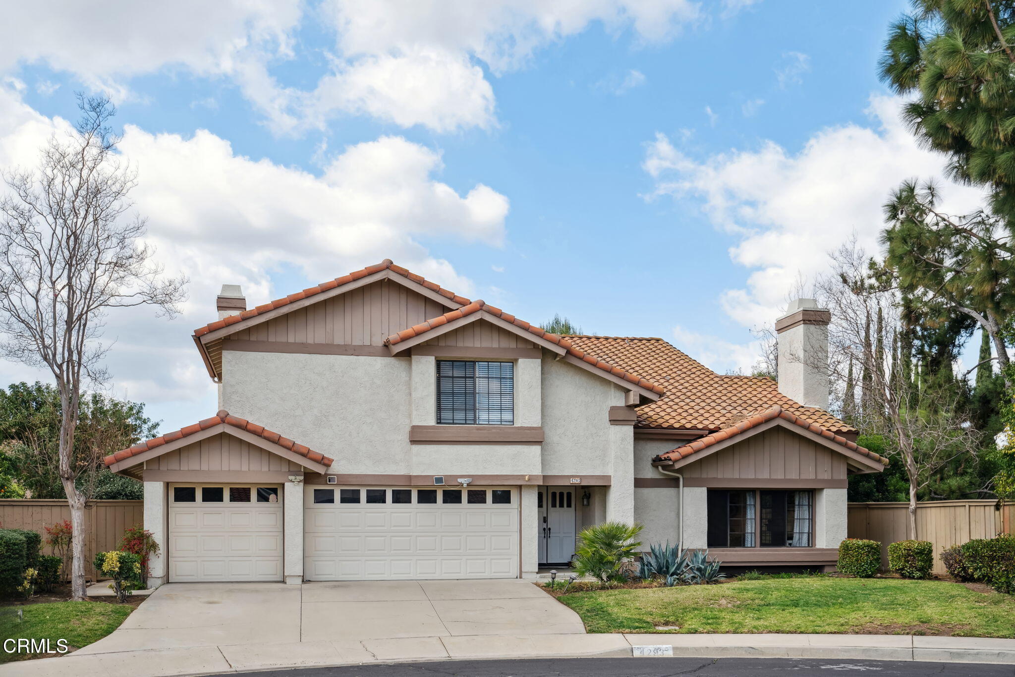 4293 Peach Slope Road Moorpark, CA 93021 - Photo 35 of 36 a view of a white house next to a yard with large trees