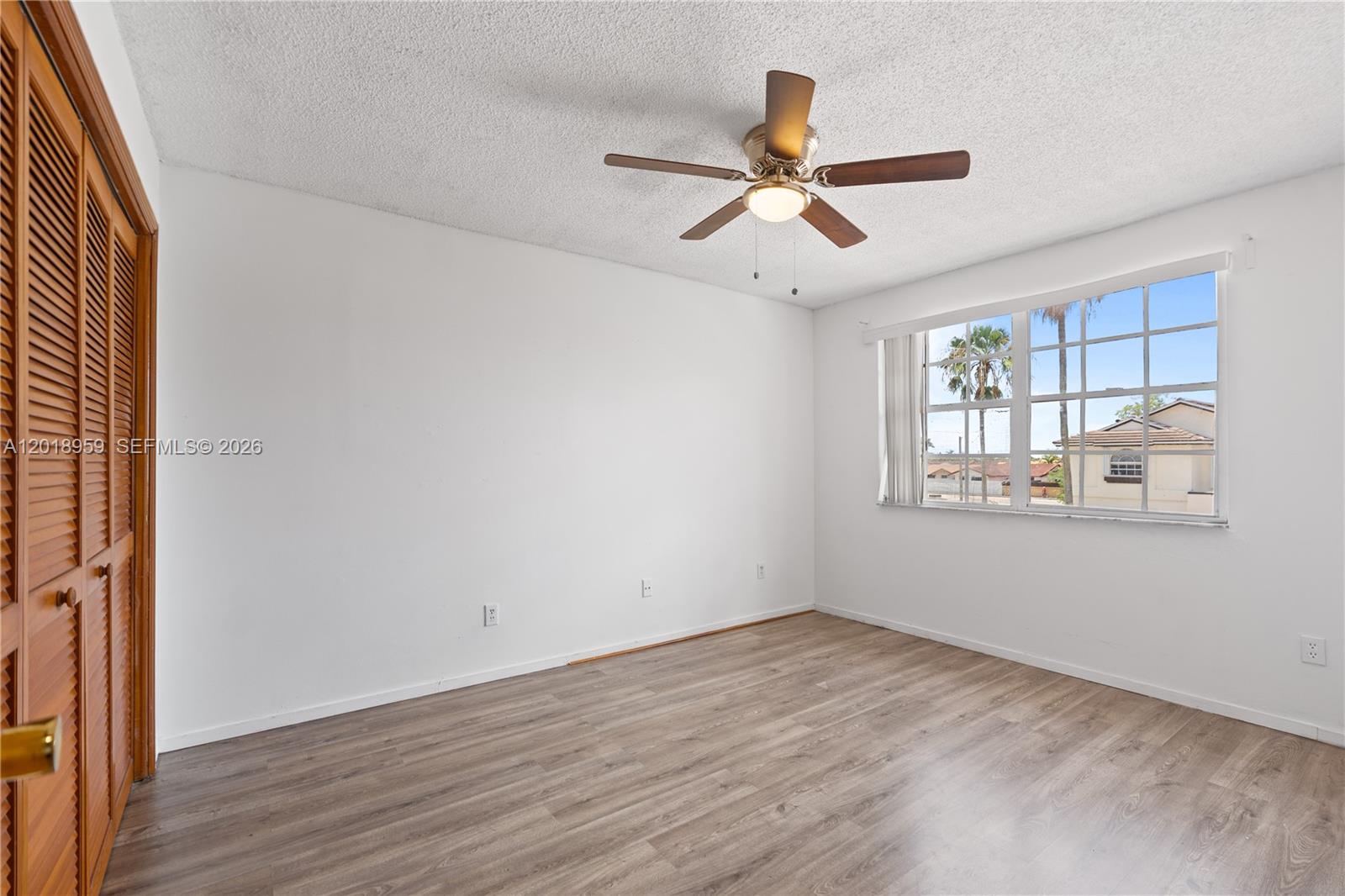 15345 Southwest 63rd Terrace Miami, FL 33193 - Photo 28 of 51 a view of an empty room with wooden floor and a window