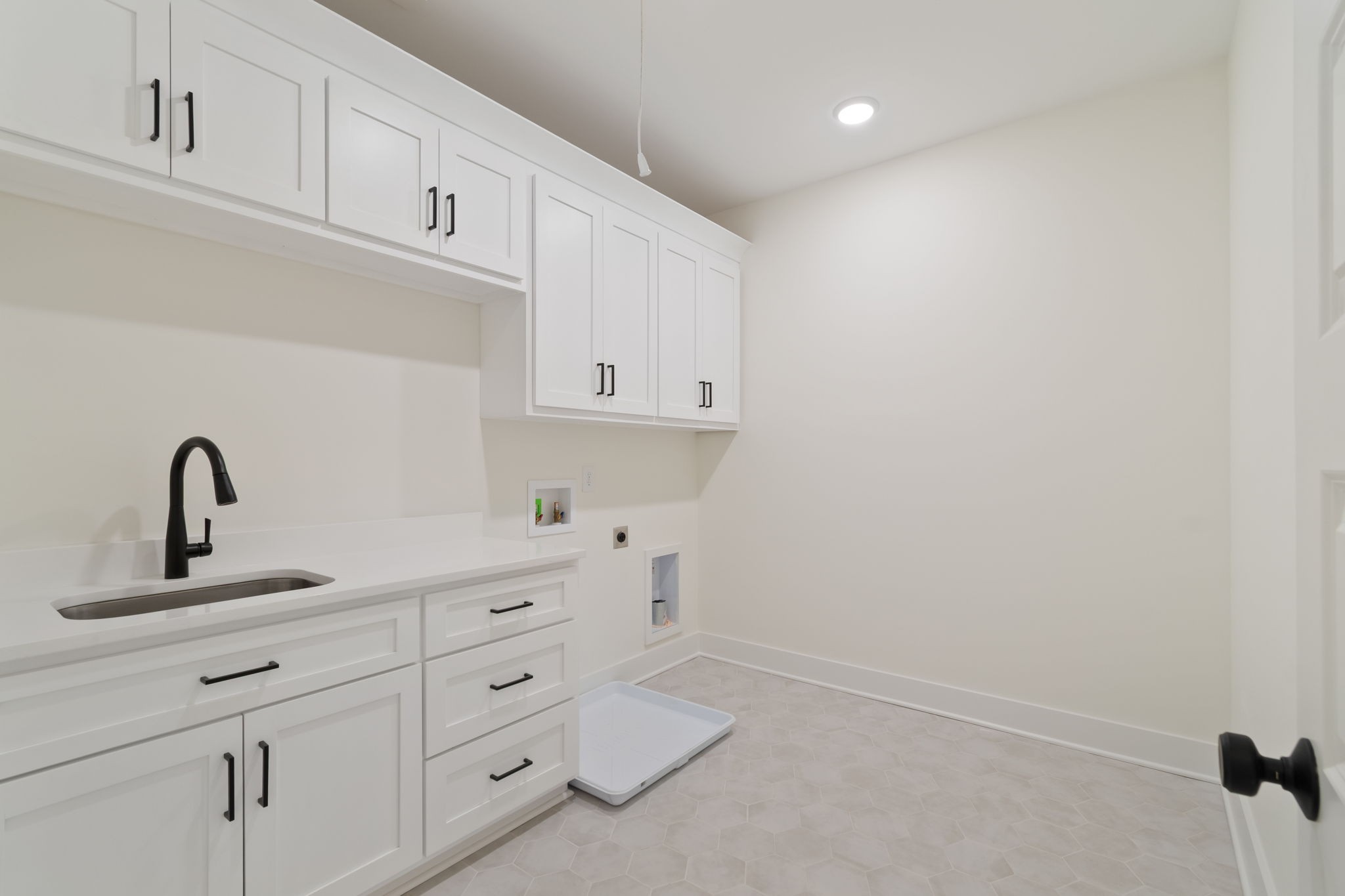 1004 Pheasant Court Spring Hill, TN 37174 - Photo 12 of 22 a kitchen with white cabinets and sink