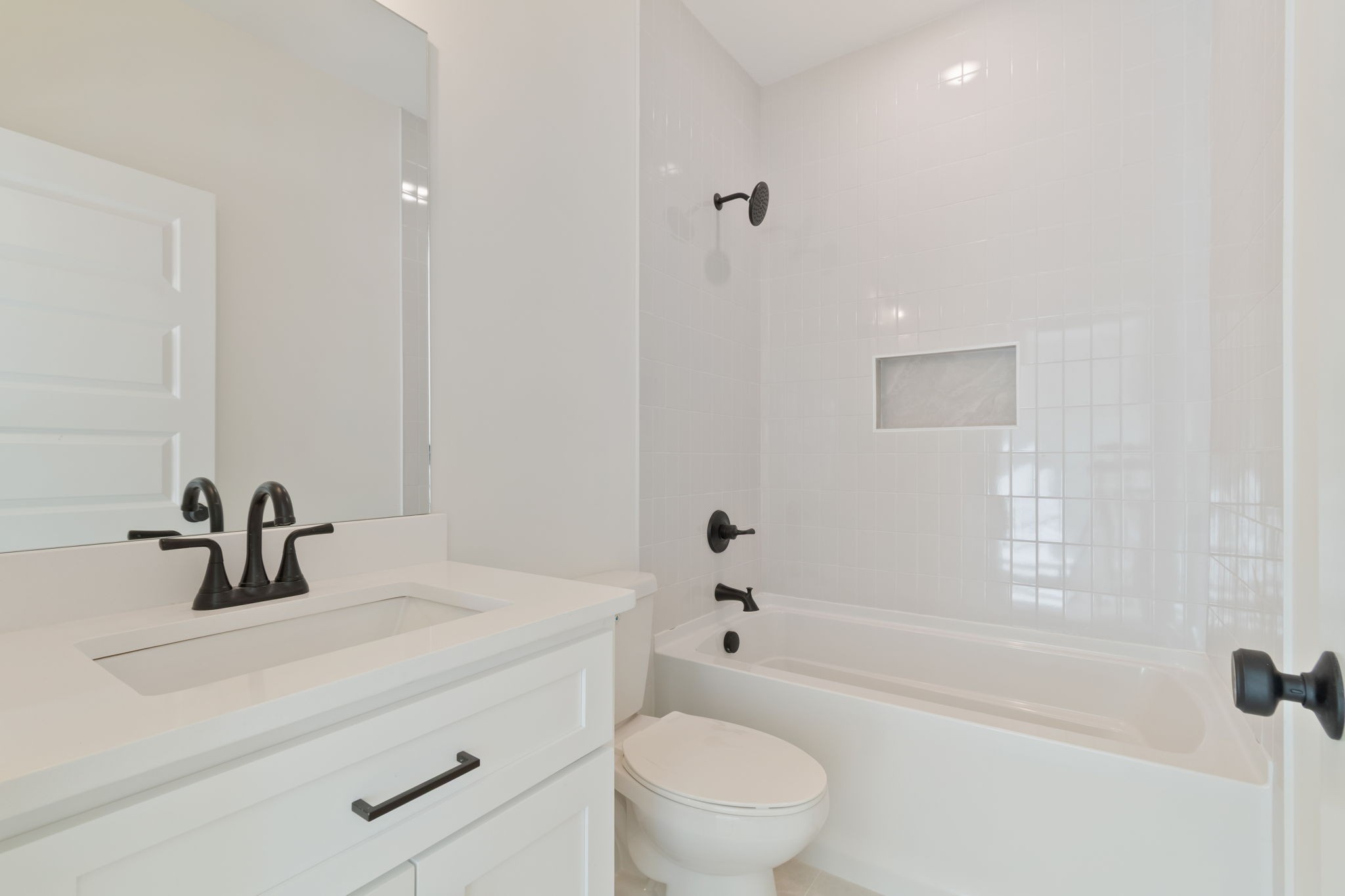 1004 Pheasant Court Spring Hill, TN 37174 - Photo 18 of 22 a bathroom with a sink a toilet and shower