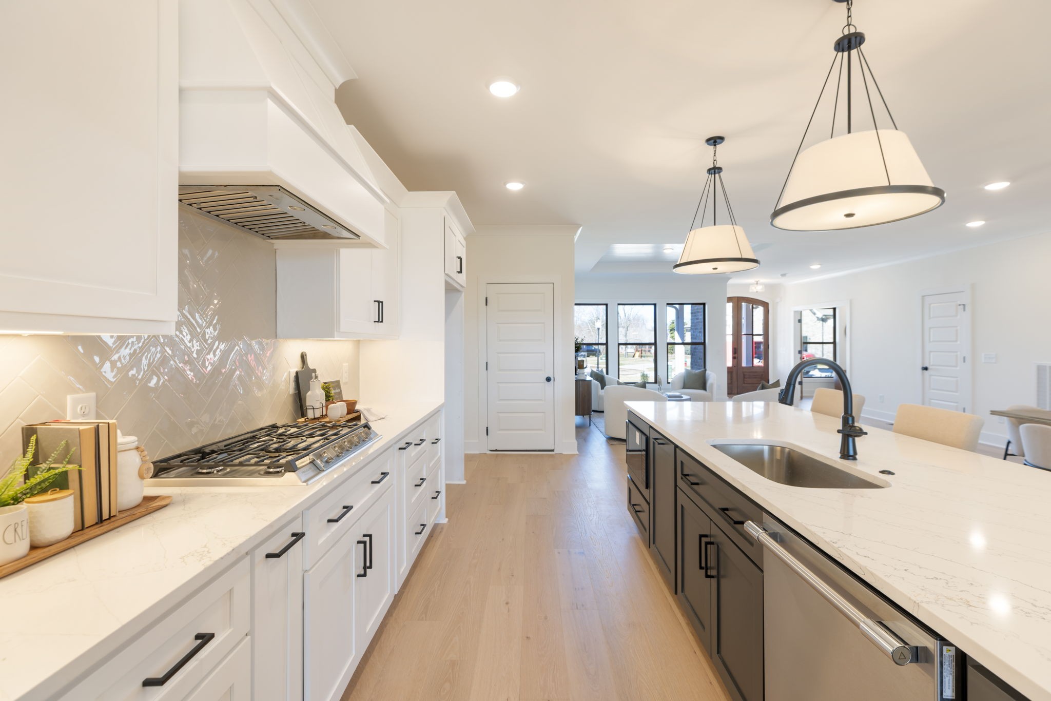 1004 Pheasant Court Spring Hill, TN 37174 - Photo 2 of 22 a kitchen with kitchen island granite countertop a sink a counter space and cabinets