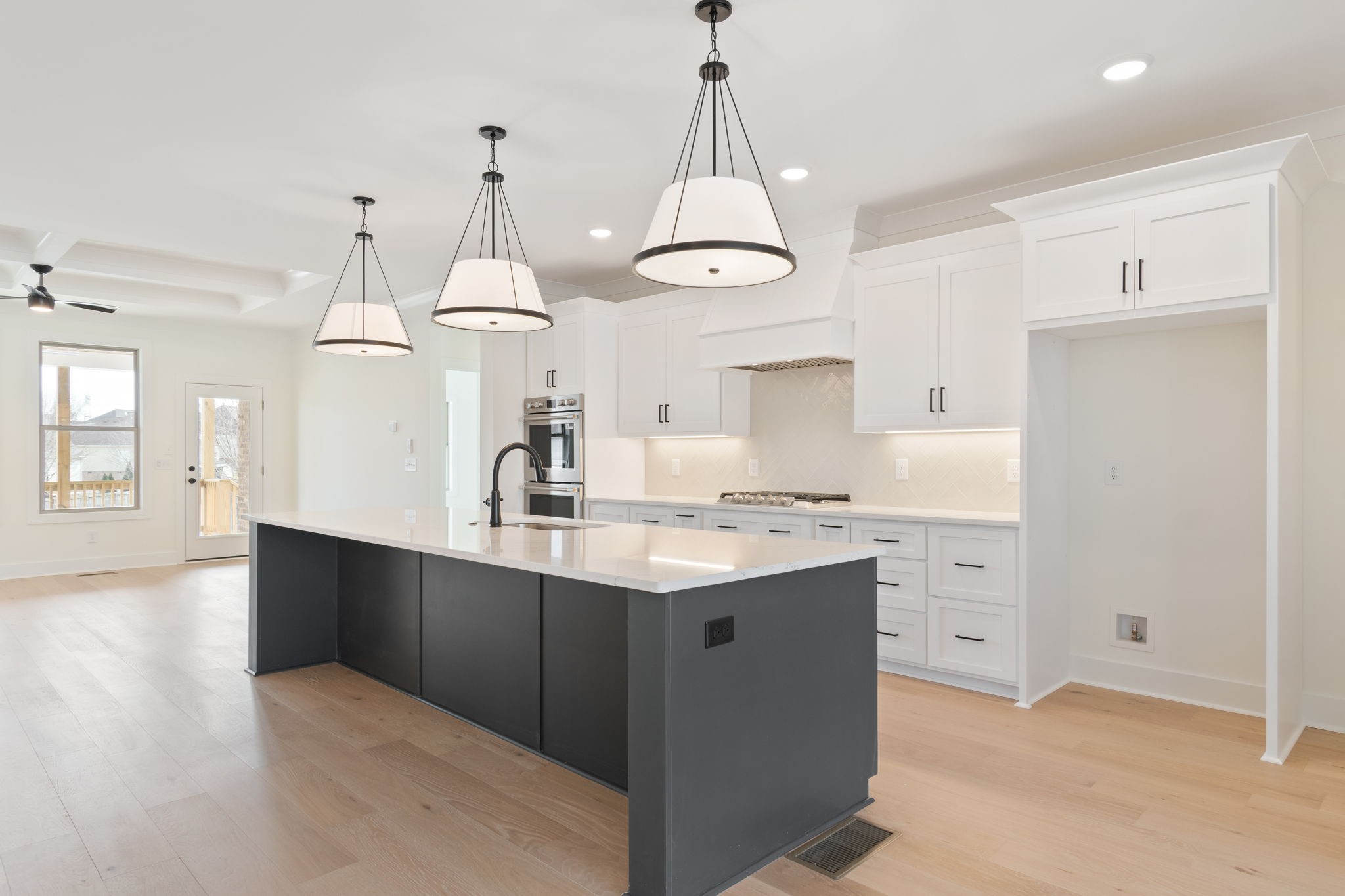 1004 Pheasant Court Spring Hill, TN 37174 - Photo 6 of 22 a kitchen with kitchen island granite countertop a sink a counter space appliances and cabinets