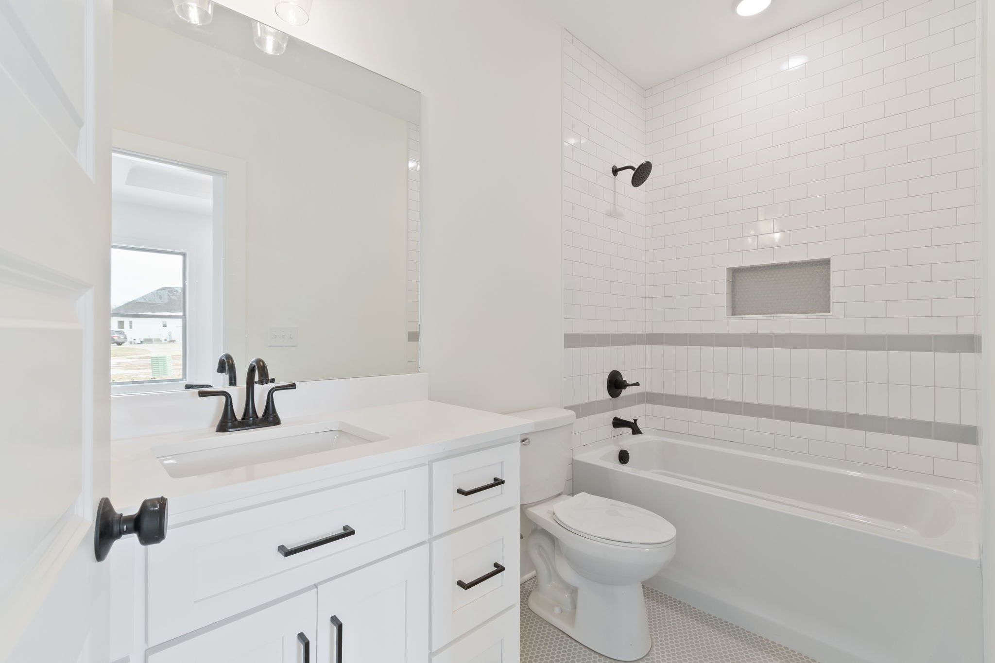 1004 Pheasant Court Spring Hill, TN 37174 - Photo 10 of 22 a bathroom with a sink a toilet and shower