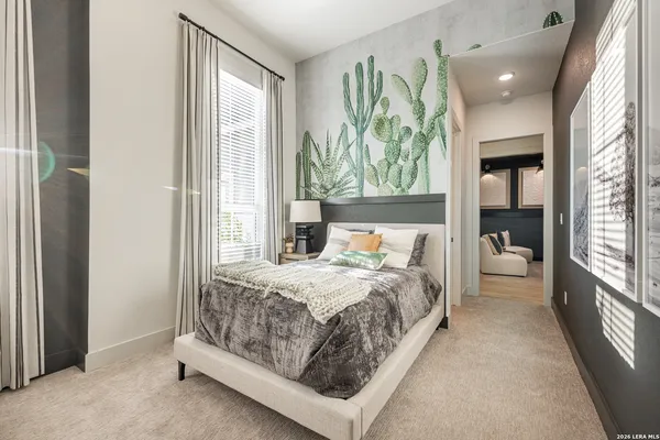 a bedroom with a large bed and a window