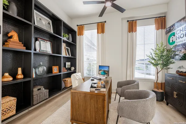 a living room with furniture cabinets and a window
