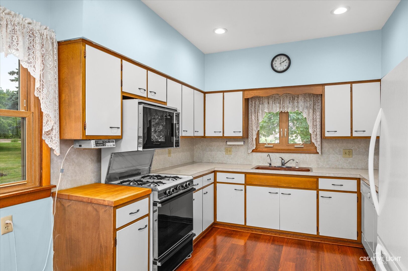 92 Maple Street Sugar Grove, IL 60554 - Photo 11 of 40 a kitchen with stainless steel appliances granite countertop a stove a sink and a microwave