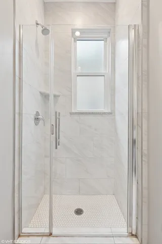 a bathroom with a glass shower door