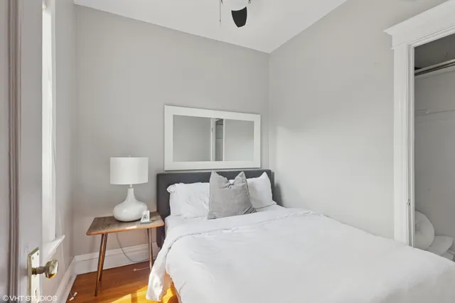 a bedroom with a bed and chair