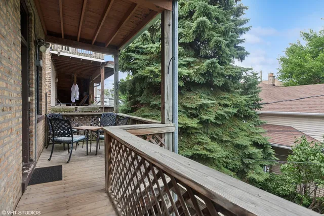 a view of a chairs and table in the balcony