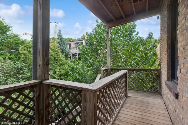a view of a balcony with wooden floor