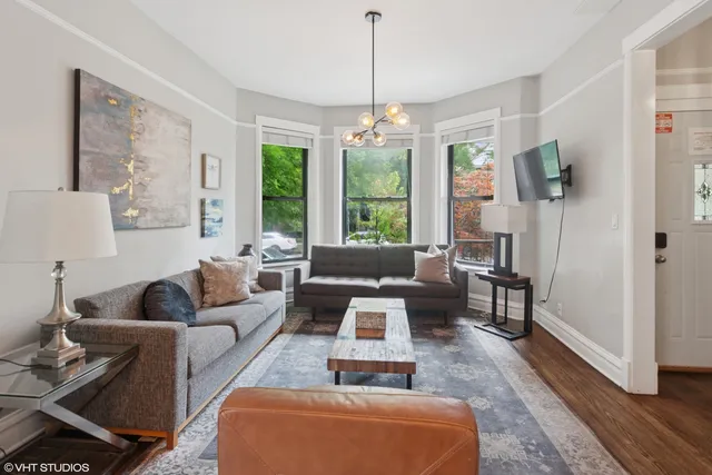 a living room with furniture ceiling fan and a window