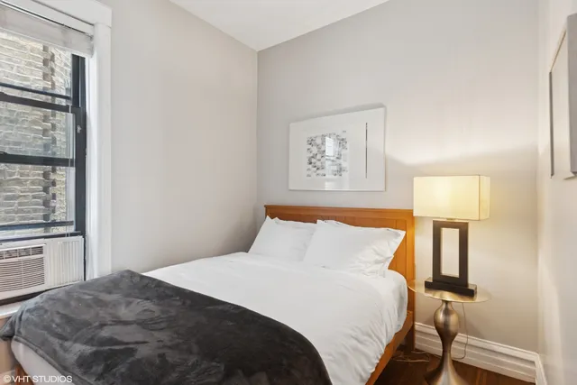 a bedroom with a bed and a lamp