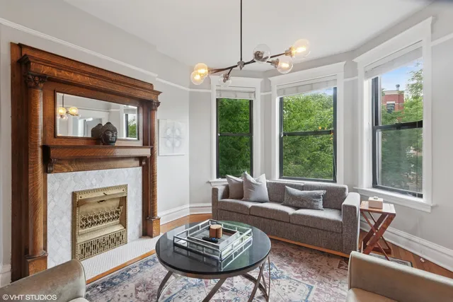 a living room with furniture a table and a fireplace