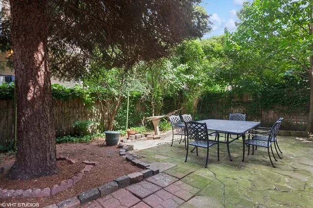 a view of backyard with seating and green space