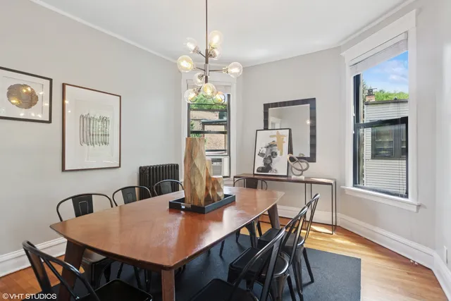a dining room with furniture a window and wooden floor