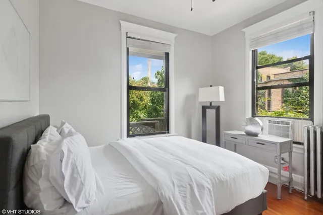 a bedroom with a bed and a window