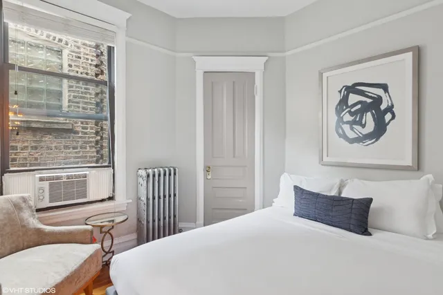 a bedroom with a bed and a chair