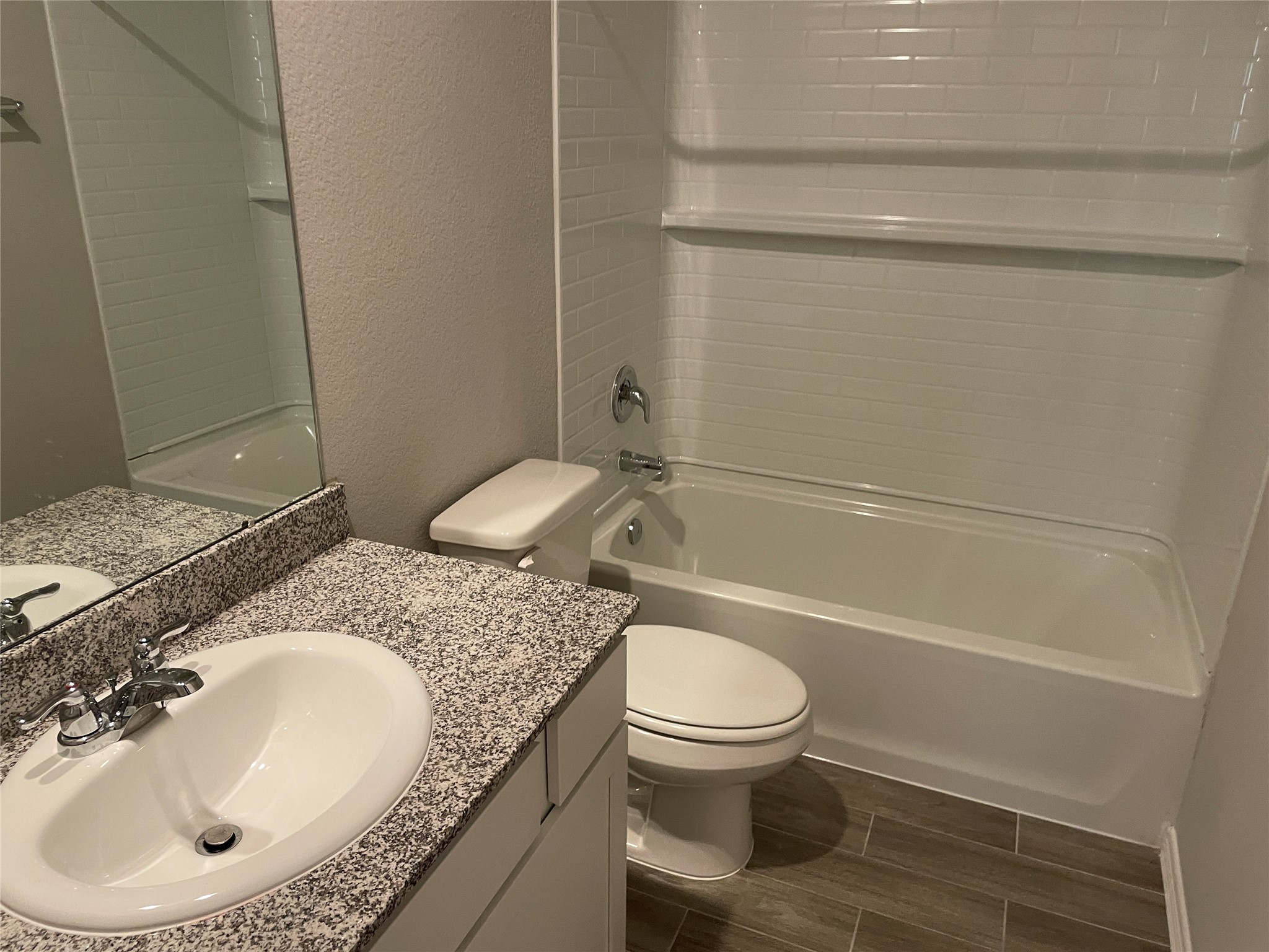 914 Redinger Ridge Drive Houston, TX 77336 - Photo 10 of 16 a bathroom with a granite countertop sink toilet and shower