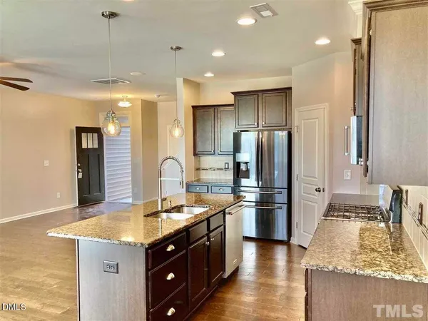 a kitchen with a refrigerator sink and stove