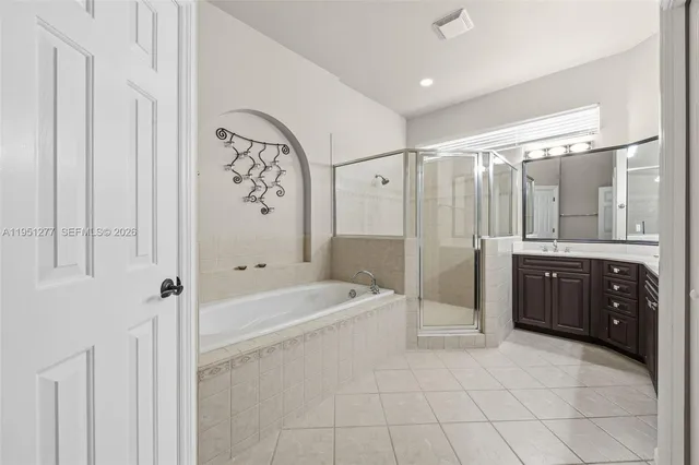 a bathroom with a bathtub a shower a sink and a mirror