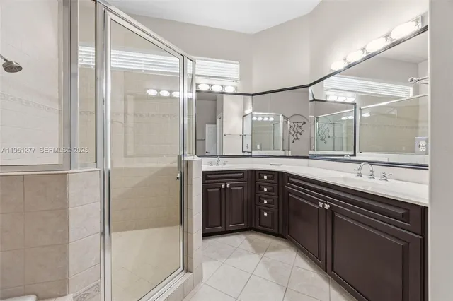 a spacious bathroom with a granite countertop sink mirror and double