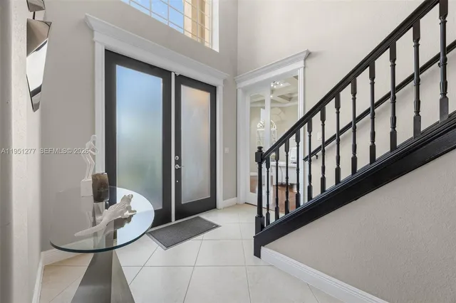 a view of staircase with lots of frames and a potted plant
