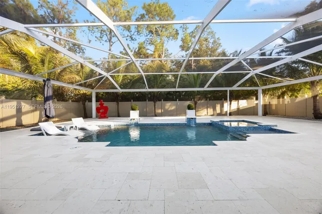 a bedroom with furniture and a large window
