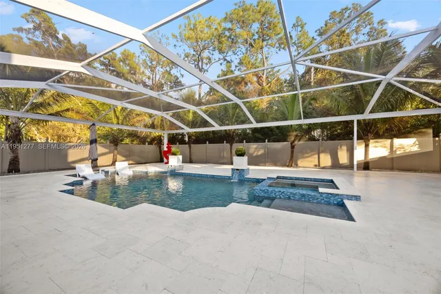 a view of a patio with a table and chairs under an umbrella