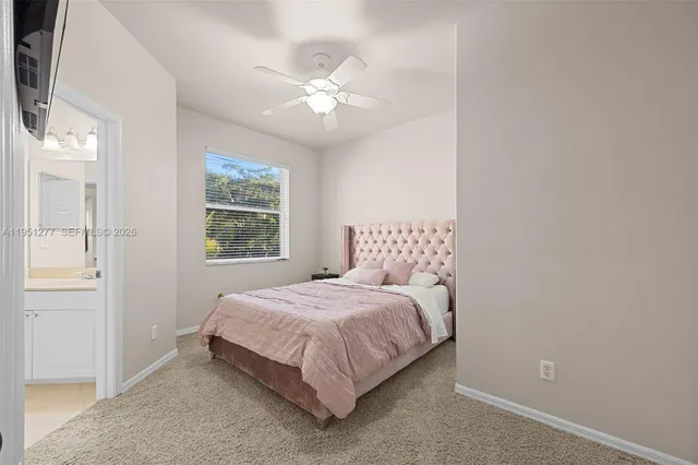 a living room with furniture a ceiling fan and a rug