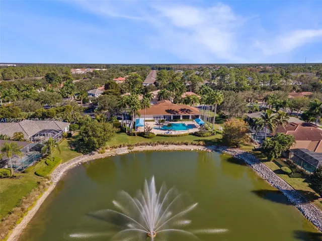 an aerial view of residential houses with outdoor space and swimming pool