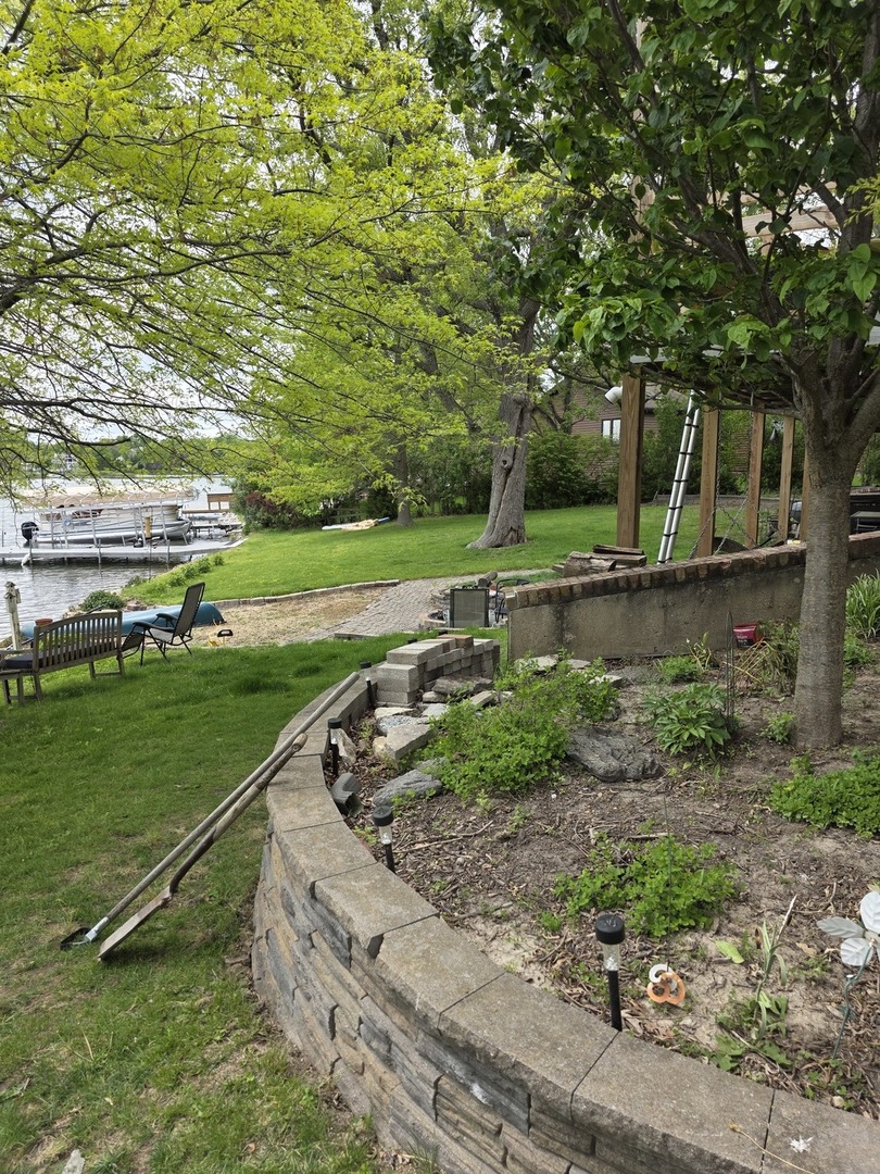 107 Comanche Trail Loda, IL 60948 - Photo 32 of 37 a garden with trees in the background