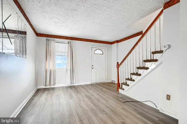 a view of an entryway with wooden floor