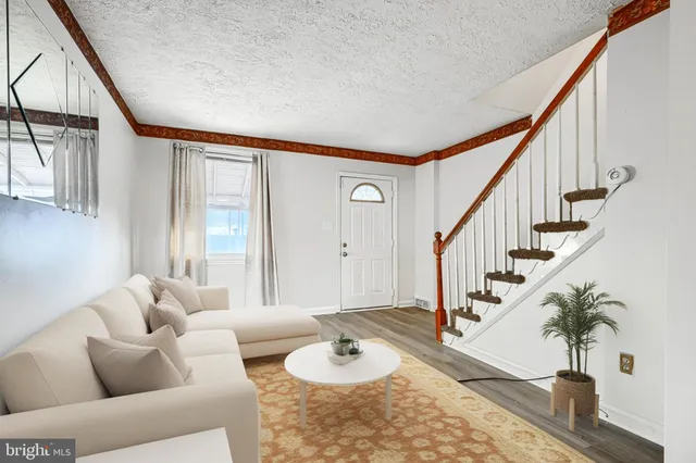 a living room with furniture and a potted plant