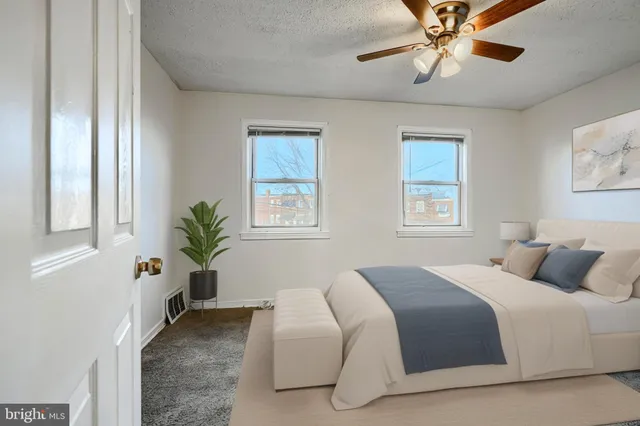 a bedroom with bed and windows