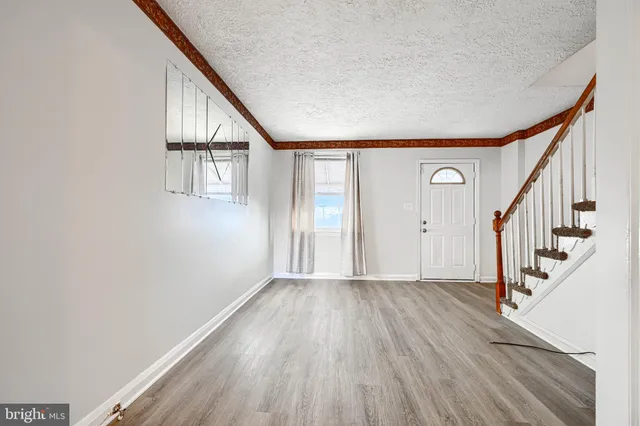a view of an entryway with wooden floor