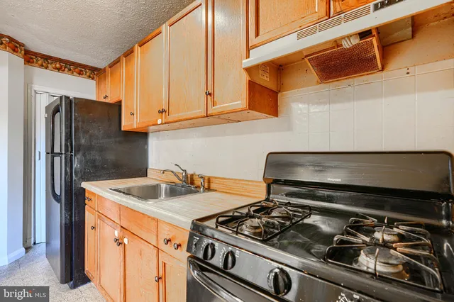 a kitchen with stainless steel appliances granite countertop a stove and a refrigerator
