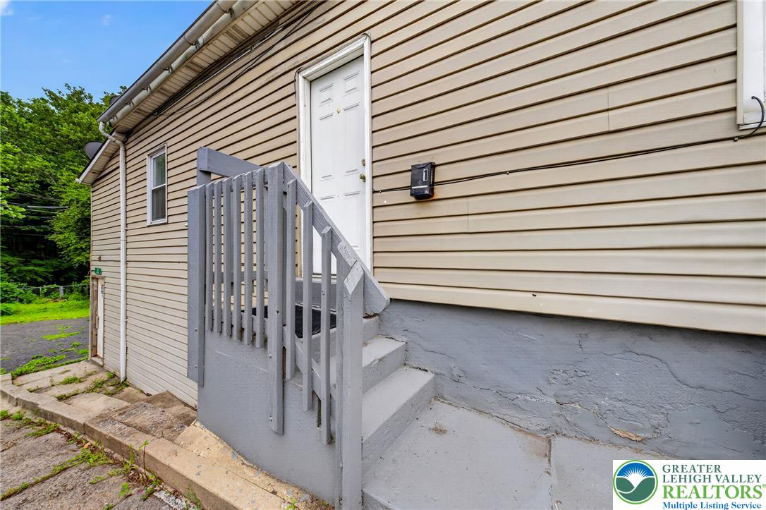 313 Main Street Slatington, PA 18080 - Photo 6 of 73 A side entrance with concrete steps leads to a door on this vinyl-sided home.