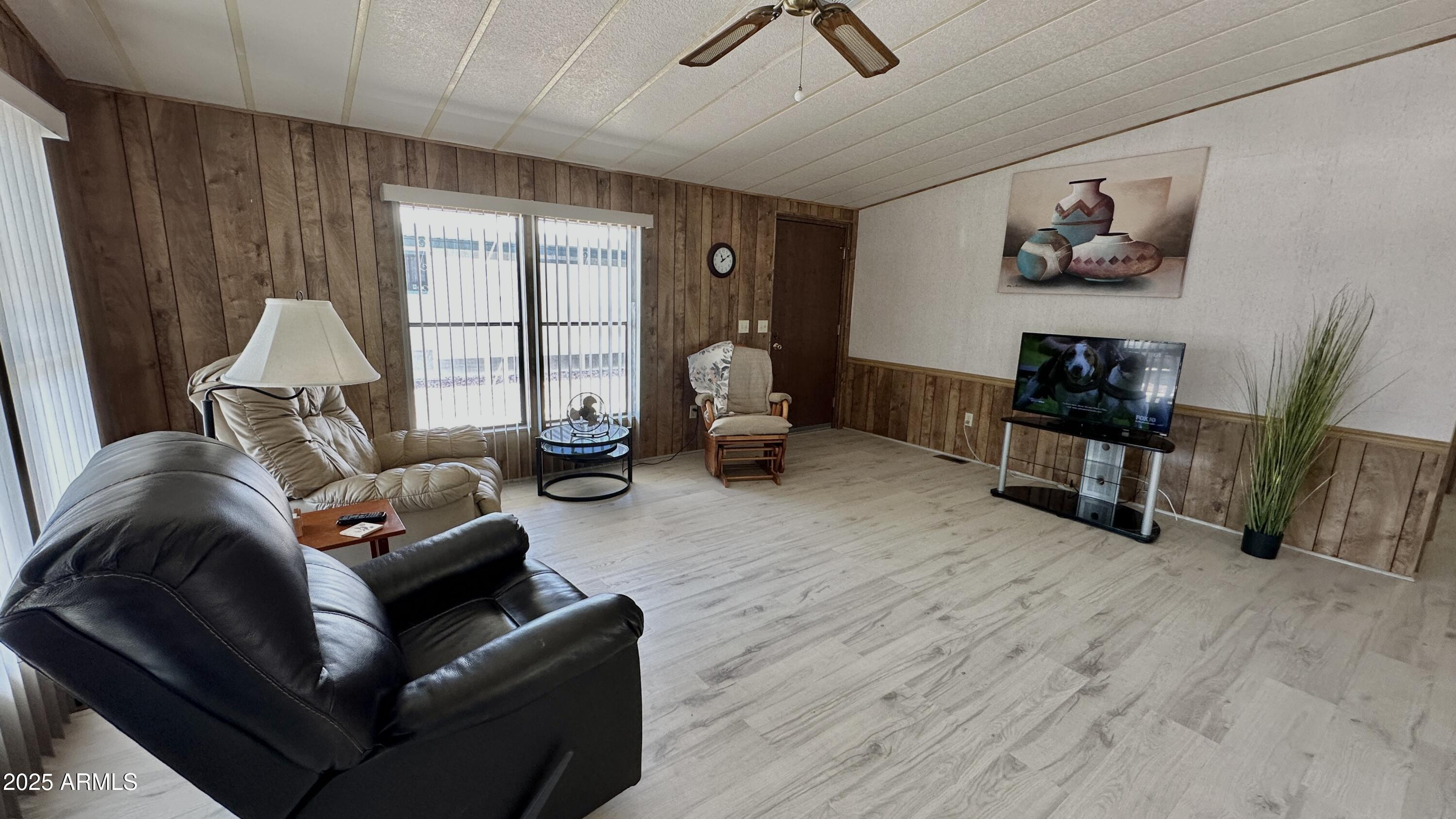 834 South Meridian Road, Unit 124 Apache Junction, AZ 85120 - Photo 11 of 28 a living room with furniture and a flat screen tv
