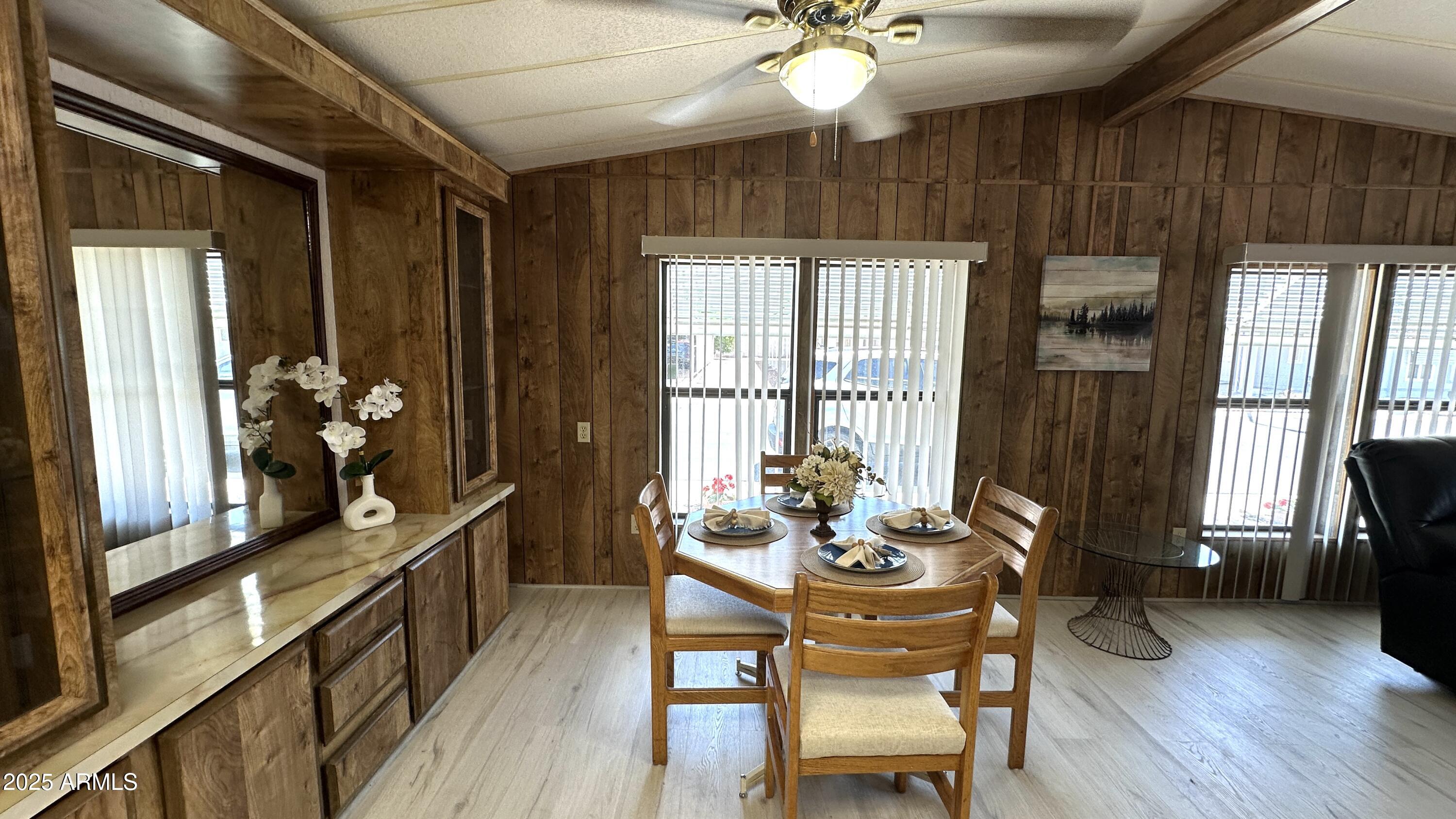 834 South Meridian Road, Unit 124 Apache Junction, AZ 85120 - Photo 15 of 28 a dining room with furniture a chandelier and wooden floor