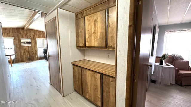 a view of washer and dryer with kitchen in the background